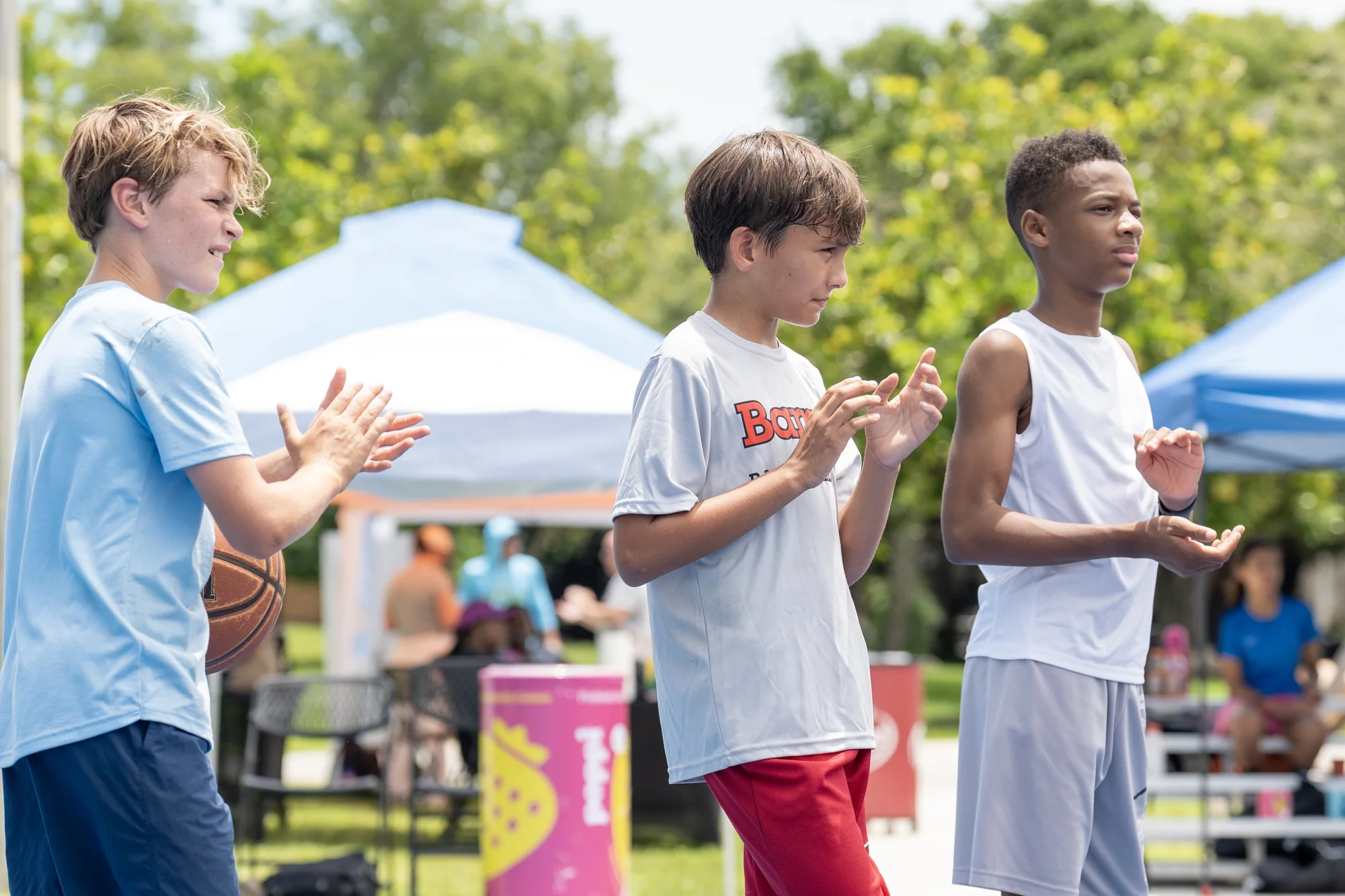Youth athletes gathering on an outdoor basketball court during the 2026 festival