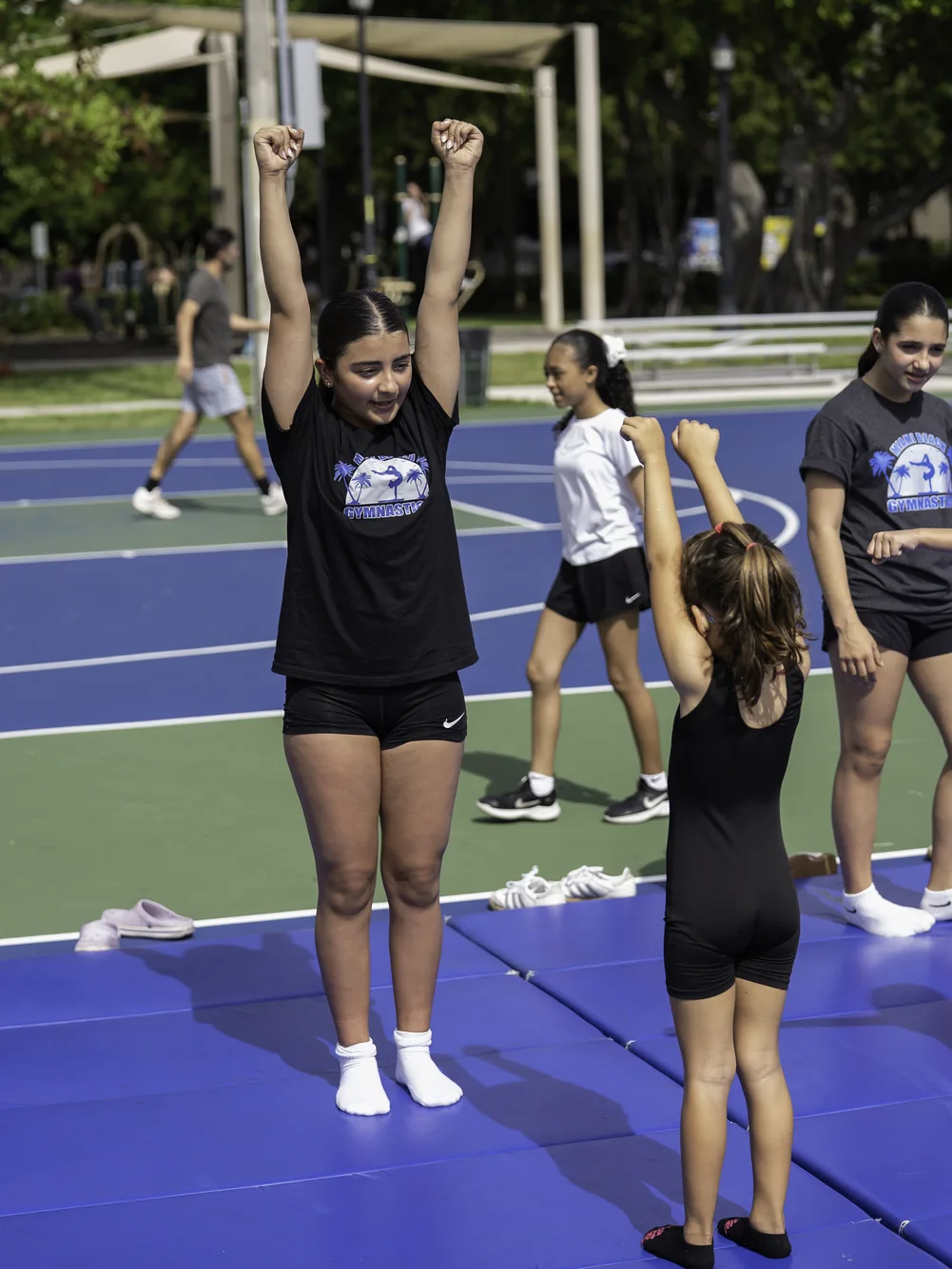 Young gymnast being assisted with a skill during the 2026 festival gymnastics activity