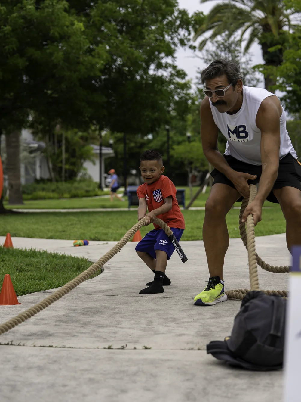 Young participant stepping over an obstacle during a 2026 festival fitness challenge