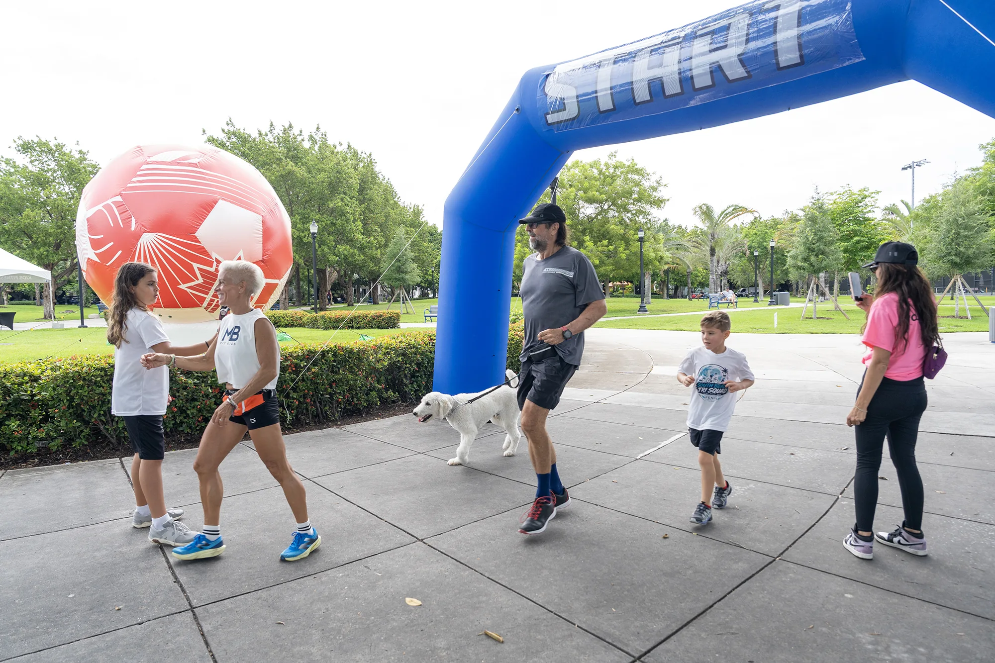 Families gathering for a 2026 festival run near the blue start arch