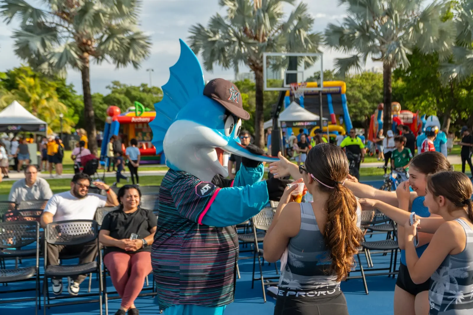Mascot greeting families and children at Flamingo Park